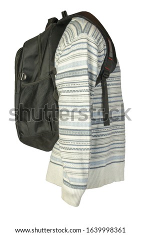 black backpack dressed in a knitted white blue gray color sweater isolated on a white background. backpack and male sweater side view