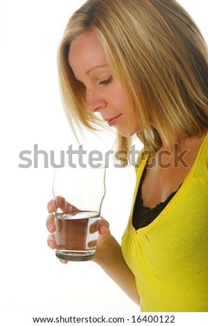 Attractive blond woman looking into a glass of water. Portion of photographers commission of this image will be donated to Autism Ontario.