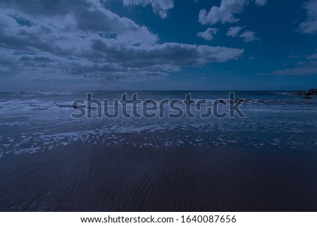 Photography of the Atlantic ocean waves roll ashore. Sandy beach in sunset. Northern Portugal is full of wildness and freshness. The beauty of nature concepts. 