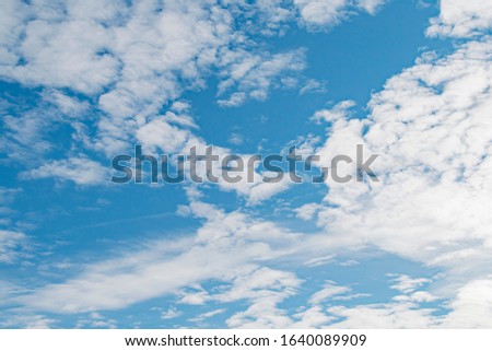 White clouds on a blue sky on a Sunny day