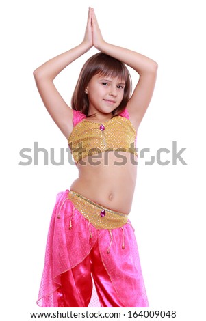 pretty smiley little arabic dancer over Christmas decoration  isolated on white