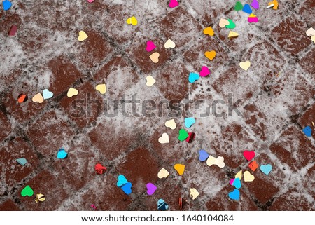 Confetti hearts on the snow-covered ground
