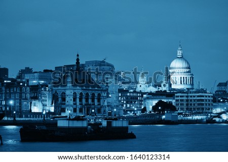 St Pauls Cathedral over Thames River at night in London in black and white.