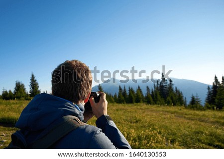 photographer at work in the mountains                              