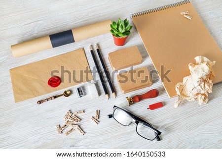 Blank kraft stationery set on light wood table background. ID template. Mockup for branding identity for designers.