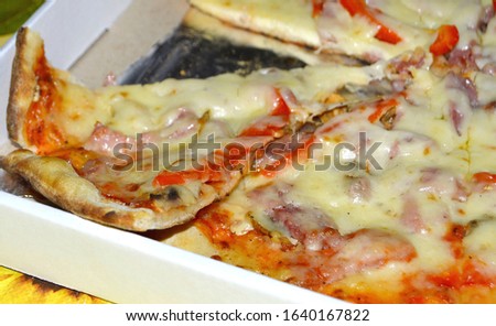 Ready pizza. Pizza with ham. Italian national dish in the form of round open tortillas with tomato sauce, cream cheese, ham, seafood. It can also be with mushrooms and other vegetables.