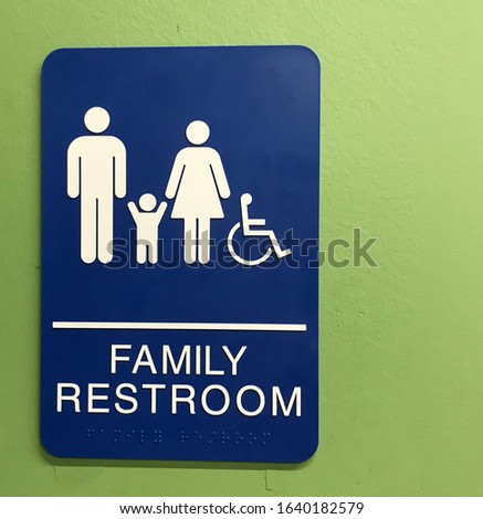 Family restroom sign with male, female, child and handicapped symbol (braille text included)