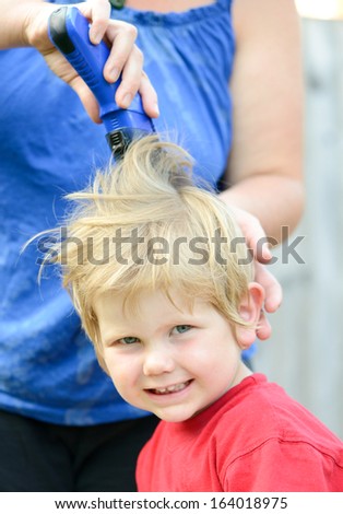 little boy having a hair cut