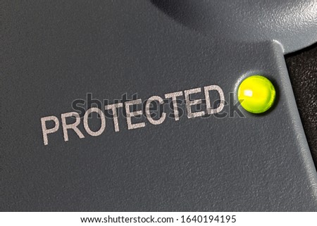 Macro close up photograph of protected indicator light on electric surge protection device. Royalty-Free Stock Photo #1640194195