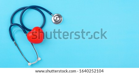 Doctor's Day concept, flat lay top view, stethoscope with red hearts diagnosis of heart disease on blue background with copy space for text Royalty-Free Stock Photo #1640252104