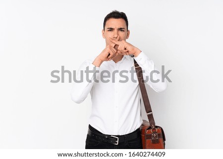 Young handsome businessman on isolated background showing a sign of silence gesture
