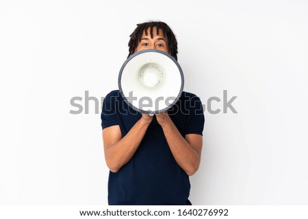Young african american man isolated on white background shouting through a megaphone
