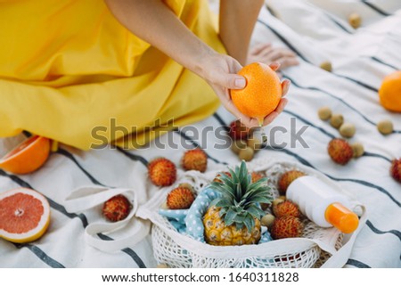 Woman with exotic fruits on the beach