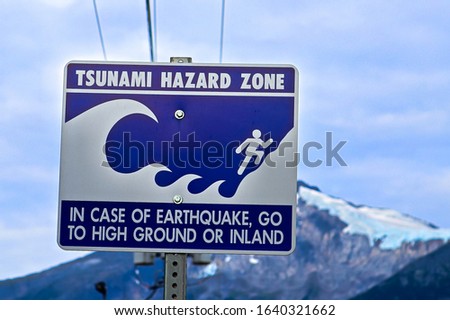 A tsunami hazard zone sign warning along the coast