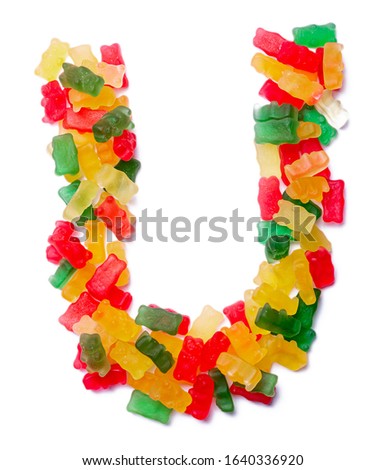 Letter U of the English alphabet  from multi-colored chewing marmalade on a white isolated background. Food pattern made ffrom children's sweets bears. Bright alphabet for kids design