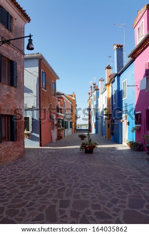              colored facade of the island of Burano in the background of blue sky, Venice, Italy.                  