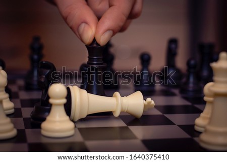 Chess board game concept for ideas and competition and strategy, business success concept.Businessman playing chess close up.