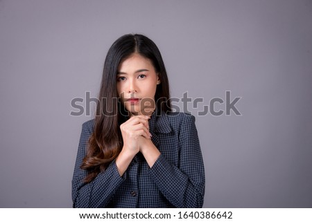 Portrait of an Asian woman, working days are very stressful.beautiful modern businesswoman , on Gray background in the studio,Vintage style pictures