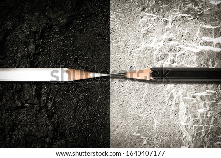 Opposite direction. The concept of confrontation and opposition. Black and white pencils on the surface with opposite colors. Royalty-Free Stock Photo #1640407177