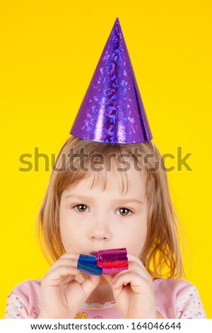 closeup image of the pretty little girl in the birthday cap