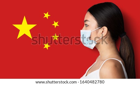 Chinese infection concept. Asian girl in medical mask looking at China country flag on red background, side view