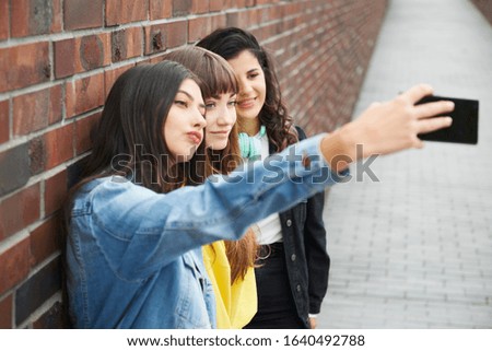 Hipster friends making a selfie by mobile phone 
