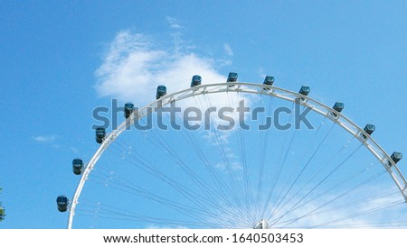 Singapore Ferris wheel during the day. Ferris wheel in the sunny sky. A huge wheel, very beautiful to behold. especially when we at the top, it's very nice and beautiful sight. absent by the cool air 