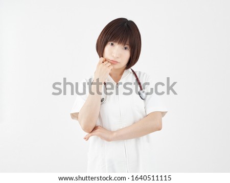 Female nurse with a face in trouble in a white background