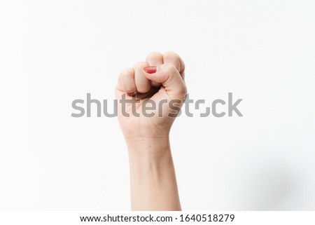 Woman's hands with fist gesture on a white background