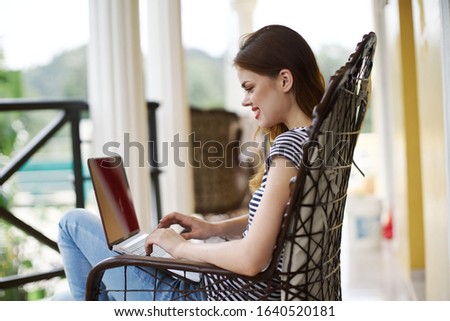 young women with laptop in summer t-shirt outdoors