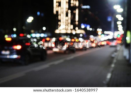 Defocused picture of a dark night street car traffic and lights