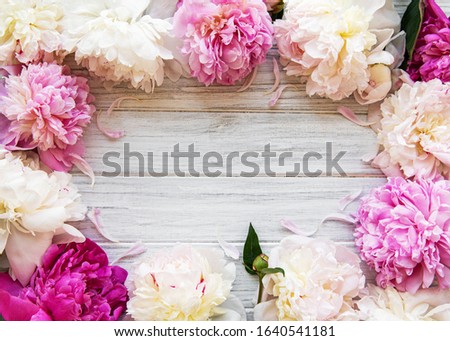 Background with pink peonies on white wooden board