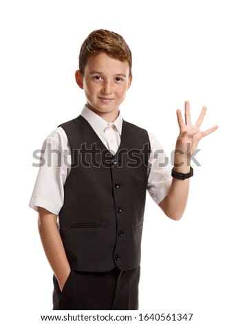 Portrait of smiling smart boy in school uniform showing four fingers