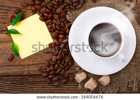 Coffee cup and saucer on  wooden table. Free space for your text