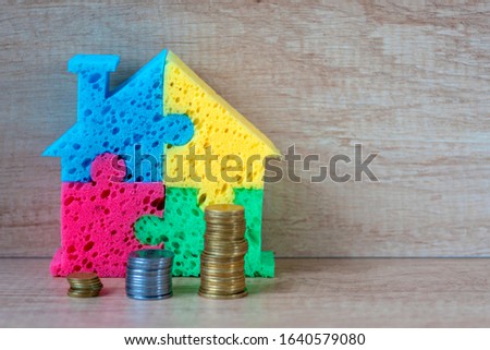 House with coins. Concept purchase, rent of housing, The rise in lodging prices, Investing in housing, habitation price, Real estate investment. Copyspace
