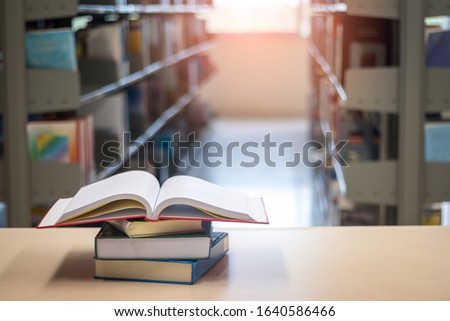 Stack of book on table in library.
