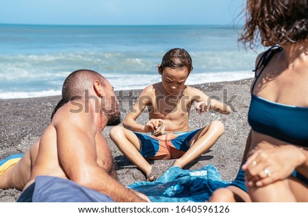Close up of kid playing in black sand beach
