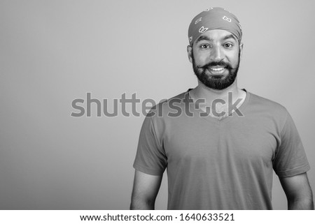 Portrait of young handsome bearded Indian man
