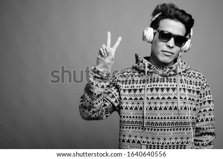 Portrait of young Asian man listening to music