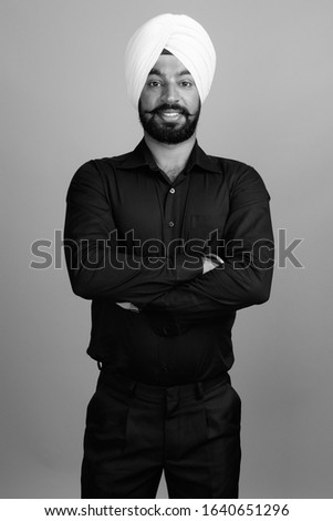 Portrait of young bearded Indian Sikh businessman with turban
