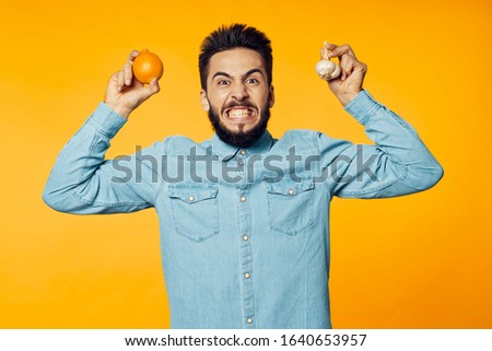 male young guy with oranges isolated background