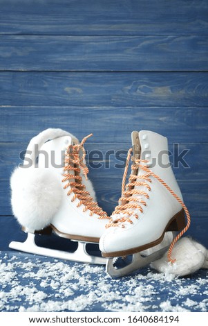 Ice skate shoes on color wooden background