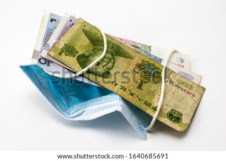 concept coronovirus and economy of china chinese yuan money lie near medical hygiene mask