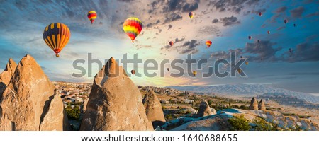 Colorful hot air balloons flying over at fairy chimneys in Nevsehir, Goreme, Cappadocia Turkey. Hot air balloon flight at spectacular Cappadocia Turkey. Royalty-Free Stock Photo #1640688655