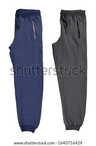 Folded blue and gray jogging pants. Isolated image on a white background. Set.
