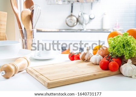 Blur an empty wooden table with fresh vegetables and spices to cook on the kitchen / area background for you to edit the product.