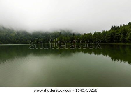 Foggy lake Karagol with reflection. Landscape photo was taken in Savsat, Artvin, Karadeniz / Black Sea region of Turkey