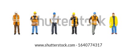 Miniature figurine character as worker wearing safety vest and posing in posture isolated on white background.