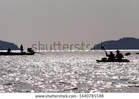 Travelers are rowing boat in the sea , Chantaburi province , Thailand silhouette picture