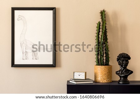 Stylish interior of living room with black mock up poster frame, cacti, gold clock, blue navy commode, books and elegant personal accessories. Beige walls. Modern home staging. Template.